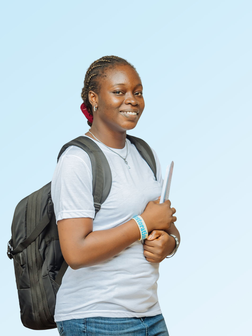 Dedicated student with backpack and laptop walking to class at Nigerian university
