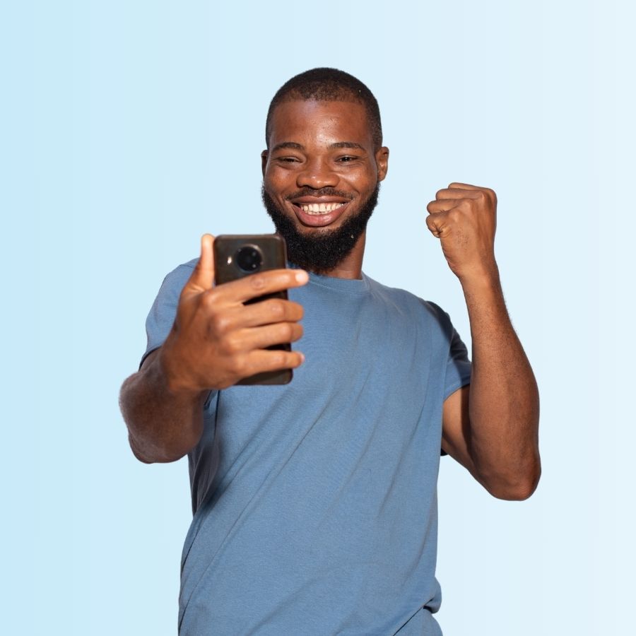 Overjoyed Nigerian university student celebrating with his phone after discovering STUBUD benefits