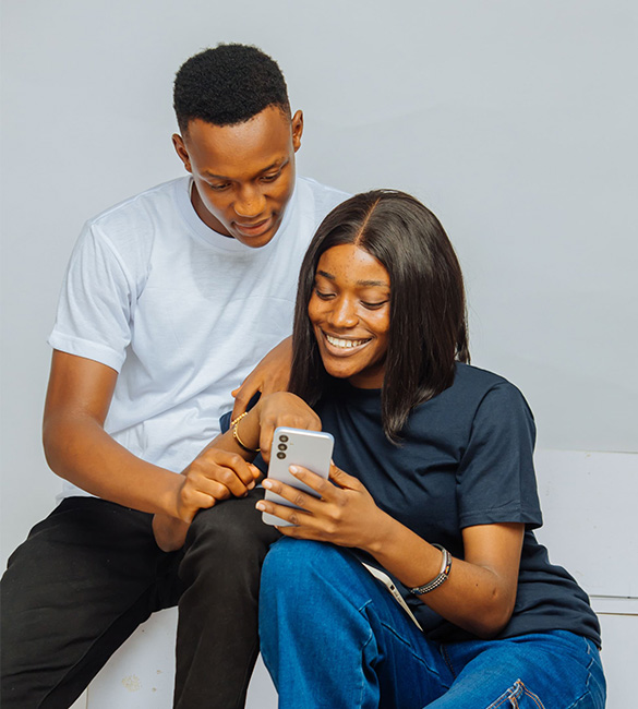 Two Nigerian students scrolling through STUBUD's student app on a mobile device